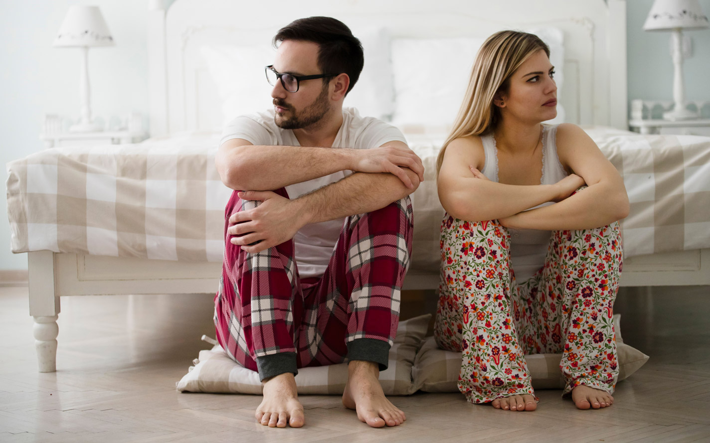 man with peyronies disease facing away from his wife.